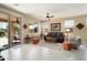 Bright living room with neutral tones, tile flooring, and sliding glass doors to the patio at 21573 N 261St Ave, Buckeye, AZ 85396