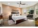 Spacious bedroom features a ceiling fan, area rug, and large windows for ample natural light at 21573 N 261St Ave, Buckeye, AZ 85396