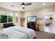 Bright bedroom featuring an entertainment center and seating, providing a comfortable and inviting atmosphere at 21573 N 261St Ave, Buckeye, AZ 85396