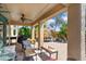 Serene covered patio with multiple seating areas, ideal for relaxation and outdoor entertaining at 21573 N 261St Ave, Buckeye, AZ 85396