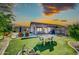 Spacious backyard featuring a pool, patio, lush grass, and desert landscaping at 21605 N 48Th Pl, Phoenix, AZ 85054