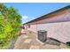 Side exterior view of home featuring AC unit, easy access, and desert landscaping at 21605 N 48Th Pl, Phoenix, AZ 85054