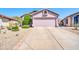 A well-maintained home with desert landscaping, a two-car garage, and a concrete driveway at 21605 N 48Th Pl, Phoenix, AZ 85054