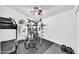 Home gym with weight machine, treadmill, and rubber floor at 21605 N 48Th Pl, Phoenix, AZ 85054