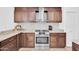 Modern kitchen with stainless steel appliances, granite countertops, and tile backsplash at 21605 N 48Th Pl, Phoenix, AZ 85054