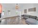 Light-filled living room with stone tile floors, grey sectional sofa, and contemporary decor at 21605 N 48Th Pl, Phoenix, AZ 85054