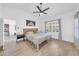 Main bedroom featuring a ceiling fan and large windows with shutters at 21605 N 48Th Pl, Phoenix, AZ 85054