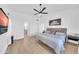 Bright primary bedroom with a ceiling fan and television at 21605 N 48Th Pl, Phoenix, AZ 85054