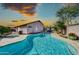 Backyard swimming pool with a baja step, lush landscaping, and patio for outdoor entertaining at 21605 N 48Th Pl, Phoenix, AZ 85054