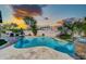 Backyard pool with baja step surrounded by lush landscaping perfect for relaxing and entertaining at 21605 N 48Th Pl, Phoenix, AZ 85054