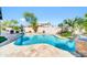 Backyard pool features rock waterfall, lush landscaping and lounge chairs at 21605 N 48Th Pl, Phoenix, AZ 85054