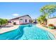 Inviting backyard pool with stone patio, and mature greenery at 21605 N 48Th Pl, Phoenix, AZ 85054