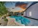 Sparkling backyard pool with a baja step, mature landscaping, and a tranquil water feature at 21605 N 48Th Pl, Phoenix, AZ 85054