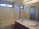 Bright bathroom features a dual sink vanity and a shower-tub combination at 2324 W Darrel Rd, Phoenix, AZ 85041