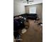 Bedroom with dark sectional and window at 2324 W Darrel Rd, Phoenix, AZ 85041