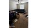 Bedroom with dark sectional and window at 2324 W Darrel Rd, Phoenix, AZ 85041
