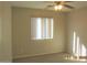 Cozy bedroom with natural light filtering through a window, complemented by a ceiling fan at 2324 W Darrel Rd, Phoenix, AZ 85041