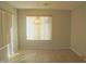 Bright dining room with large window, tile flooring, and decorative chandelier light fixture at 2324 W Darrel Rd, Phoenix, AZ 85041