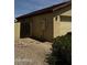 Side view of a single-story home with desert landscaping and backyard access at 2324 W Darrel Rd, Phoenix, AZ 85041