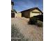 View of the front yard with desert landscaping and gated side yard at 2324 W Darrel Rd, Phoenix, AZ 85041