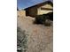 View of front yard with desert landscaping, gated side yard and partial driveway at 2324 W Darrel Rd, Phoenix, AZ 85041