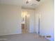 Main bedroom with neutral carpet, large windows, and ensuite bathroom at 2324 W Darrel Rd, Phoenix, AZ 85041