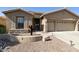 Charming single-story home showcasing a well-manicured landscape, desert accents, and a two-car garage at 24816 S Golfview Dr # 46, Sun Lakes, AZ 85248