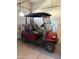 The garage features a golf cart with custom rims and seating; for driving around the neighborhood at 24816 S Golfview Dr # 46, Sun Lakes, AZ 85248