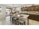 Stylish kitchen boasts stainless appliances, breakfast bar seating, tile backsplash, and access to backyard at 24816 S Golfview Dr # 46, Sun Lakes, AZ 85248