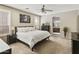 Serene main bedroom with neutral palette, ceiling fan, natural light, and en-suite bathroom access at 24816 S Golfview Dr # 46, Sun Lakes, AZ 85248