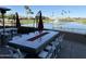 Picturesque outdoor dining area featuring a large table with a built-in fire pit and water view at 24816 S Golfview Dr # 46, Sun Lakes, AZ 85248