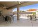 Covered patio with comfortable seating, outdoor dining, and a view of the beautifully landscaped backyard at 24816 S Golfview Dr # 46, Sun Lakes, AZ 85248