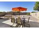 Outdoor dining space with an umbrella table and chairs, perfect for enjoying meals in the backyard at 24816 S Golfview Dr # 46, Sun Lakes, AZ 85248