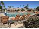 Refreshing community pool with lounge chairs, umbrellas, and palm trees at 24816 S Golfview Dr # 46, Sun Lakes, AZ 85248