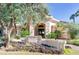 Charming Poolside Cafe entrance with lush landscaping, a stone sign, and inviting architecture at 24816 S Golfview Dr # 46, Sun Lakes, AZ 85248