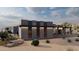 Modern home with desert landscaping, large windows, and a neutral color palette, blending with the desert environment at 29121 N 105Th St, Scottsdale, AZ 85262