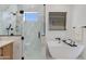 Luxury bathroom featuring a freestanding tub, glass shower, and modern finishes at 2927 E Osborn Rd, Phoenix, AZ 85016