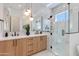 Elegant bathroom with dual sinks, marble countertops, and frameless glass shower at 2927 E Osborn Rd, Phoenix, AZ 85016