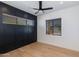 Bedroom with dark accent wall, light floors, and large windows at 2927 E Osborn Rd, Phoenix, AZ 85016