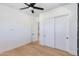 Bedroom featuring a ceiling fan, light wood floors, and a closet with sliding doors at 2927 E Osborn Rd, Phoenix, AZ 85016