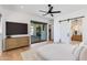 Modern bedroom with sliding glass doors, ceiling fan, and barn door to bath at 2927 E Osborn Rd, Phoenix, AZ 85016