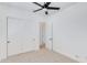 Bright bedroom featuring a ceiling fan, carpeted floors, and a closet with sliding doors at 2927 E Osborn Rd, Phoenix, AZ 85016