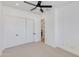 Bedroom with neutral carpet, fan, and sliding closet doors at 2927 E Osborn Rd, Phoenix, AZ 85016