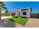 Contemporary home with a black garage door, artificial turf, and desert landscaping at 2927 E Osborn Rd, Phoenix, AZ 85016