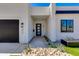 Modern home's front entrance featuring a black door, stone accents, and desert landscaping at 2927 E Osborn Rd, Phoenix, AZ 85016