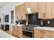 Well-appointed kitchen with designer backsplash, stainless steel range, and custom wood cabinetry at 2927 E Osborn Rd, Phoenix, AZ 85016