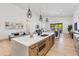Open kitchen with a large island, stainless steel appliances, and modern pendant lighting fixtures at 2927 E Osborn Rd, Phoenix, AZ 85016