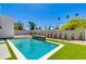 Backyard oasis showcasing the refreshing pool, green grass and block wall at 2927 E Osborn Rd, Phoenix, AZ 85016