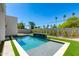 Backyard pool with fountain feature, turf, and a concrete patio surround at 2927 E Osborn Rd, Phoenix, AZ 85016