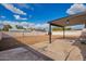 Large backyard with a covered patio and block fence under a bright blue sky at 3044 W Dahlia Dr, Phoenix, AZ 85029
